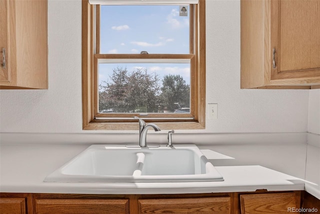 10181 Detroit Ct, Thornton, CO 80229 - kitchen featuring light countertops, brown cabinetry, and a textured wall