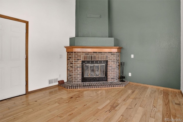 10181 Detroit Ct, Thornton, CO 80229 - unfurnished living room with wood-type flooring and a brick fireplace
