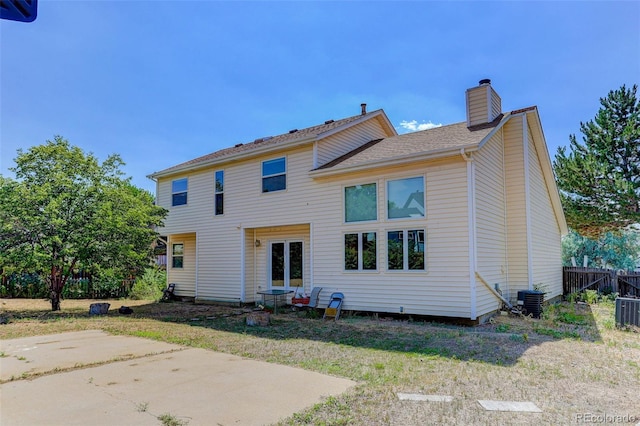 10181 Detroit Ct, Thornton, CO 80229 - rear view of property with a chimney and a patio area