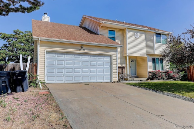 10181 Detroit Ct, Thornton, CO 80229 - view of front of home featuring an attached garage, driveway, and a chimney