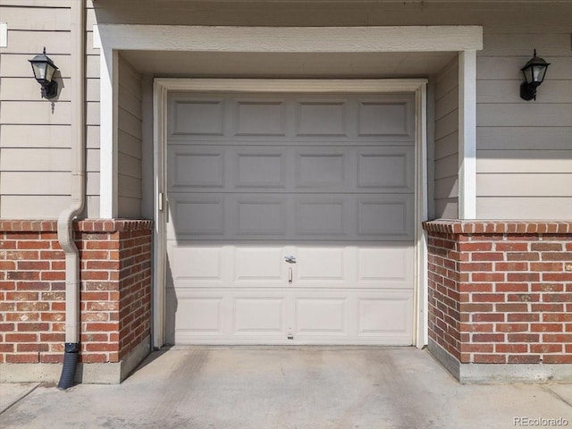 garage featuring concrete driveway