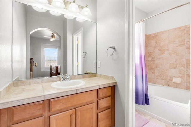 full bathroom with a ceiling fan, vanity, and shower / bath combo with shower curtain