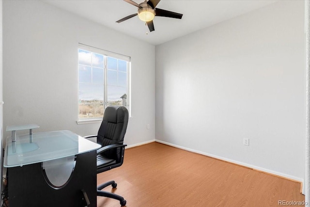 home office featuring ceiling fan, baseboards, and wood finished floors