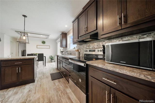 539 W 9th St, Akron, CO 80720 - kitchen with stainless steel electric stove, black microwave, light wood-style flooring, backsplash, and dark brown cabinets