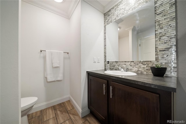539 W 9th St, Akron, CO 80720 - half bath with crown molding, backsplash, vanity, and wood finished floors