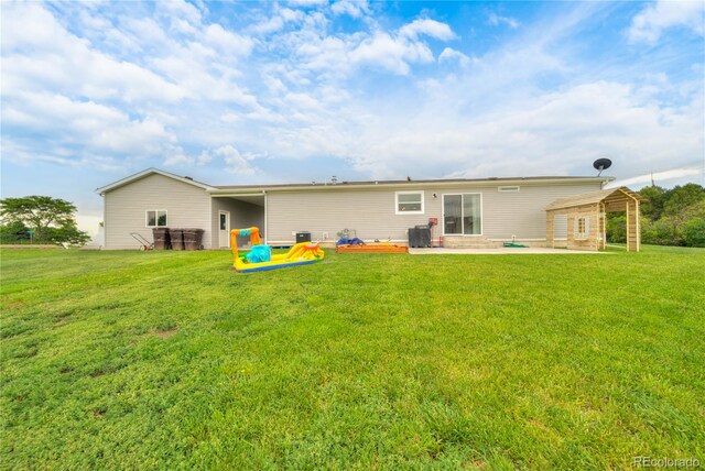 539 W 9th St, Akron, CO 80720 - back of house featuring a patio and a yard