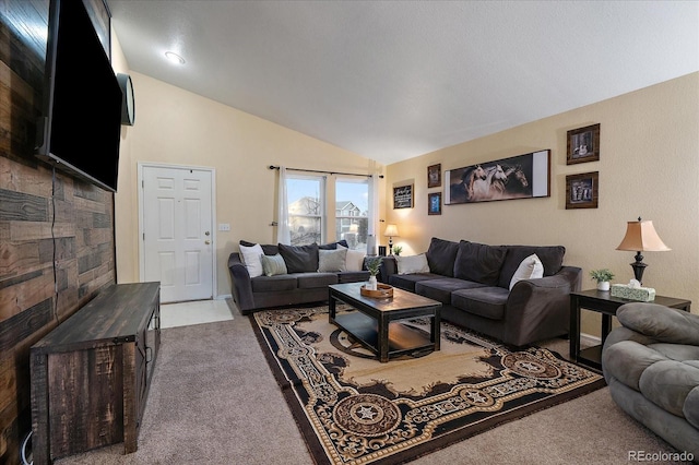 living room featuring vaulted ceiling and light colored carpet