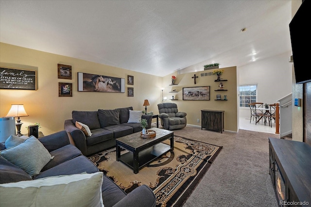 carpeted living room featuring vaulted ceiling and baseboards