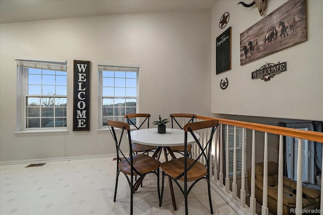 dining area with baseboards, visible vents, and tile patterned floors