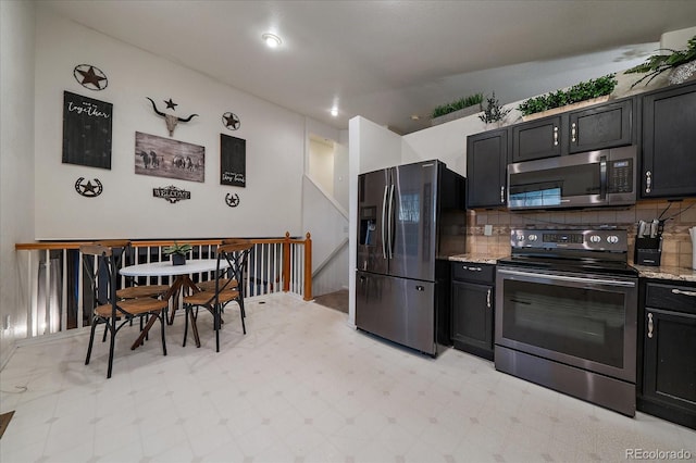 kitchen featuring electric range, fridge with ice dispenser, stainless steel microwave, and dark cabinets