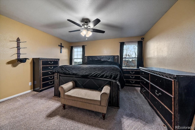 bedroom featuring carpet floors, a textured wall, a ceiling fan, a textured ceiling, and baseboards