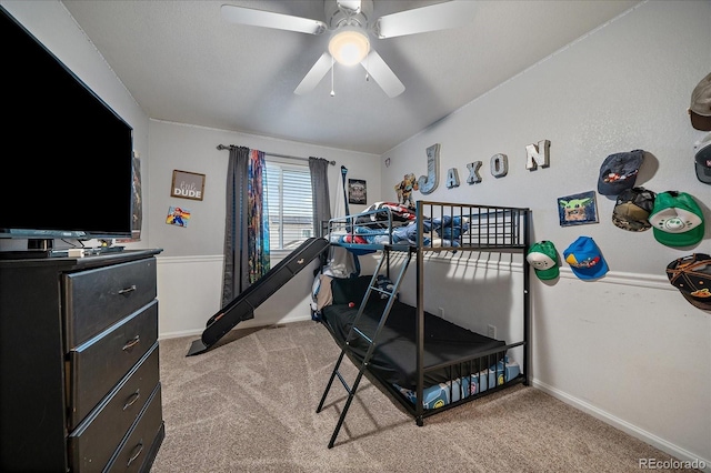 bedroom with baseboards, a ceiling fan, and light colored carpet