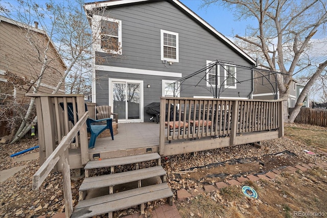 back of house with fence and a wooden deck
