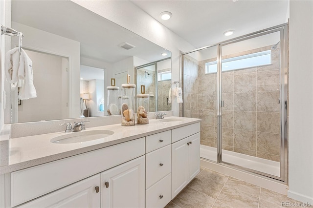 3331 N Buchanan Way, Aurora, CO 80019 - full bathroom featuring double vanity, visible vents, a stall shower, and a sink