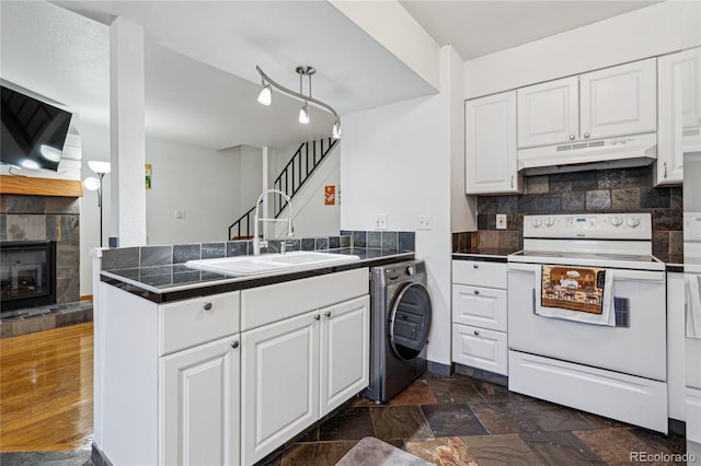 kitchen with white cabinets, washer / dryer, sink, kitchen peninsula, and electric range