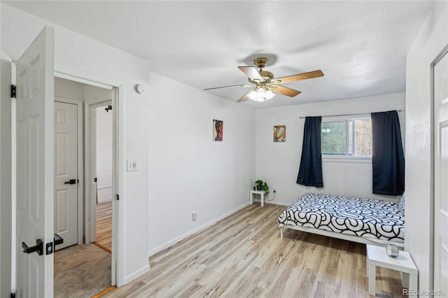 bedroom featuring light wood-type flooring and ceiling fan