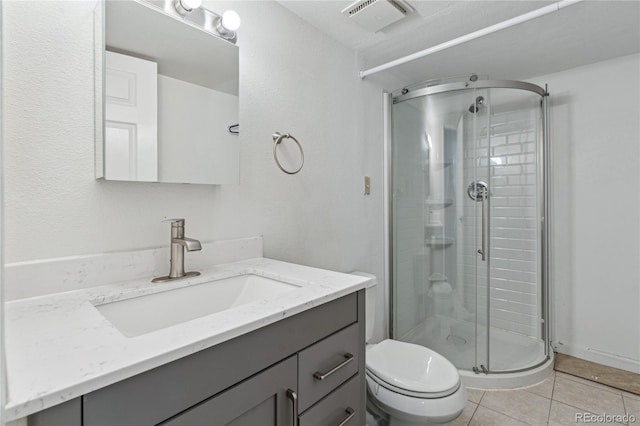 bathroom featuring vanity, toilet, tile patterned flooring, and an enclosed shower