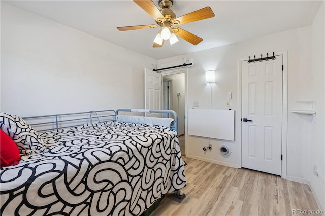 bedroom with ceiling fan and light hardwood / wood-style flooring