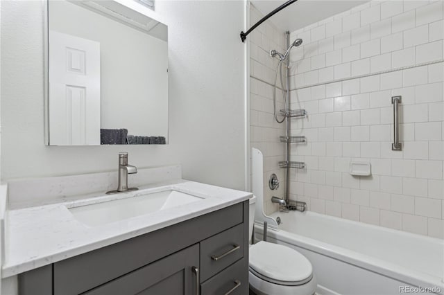 full bathroom featuring toilet, tiled shower / bath combo, and vanity