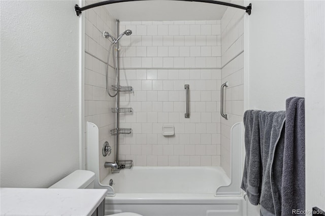 full bathroom with toilet, tiled shower / bath combo, and vanity