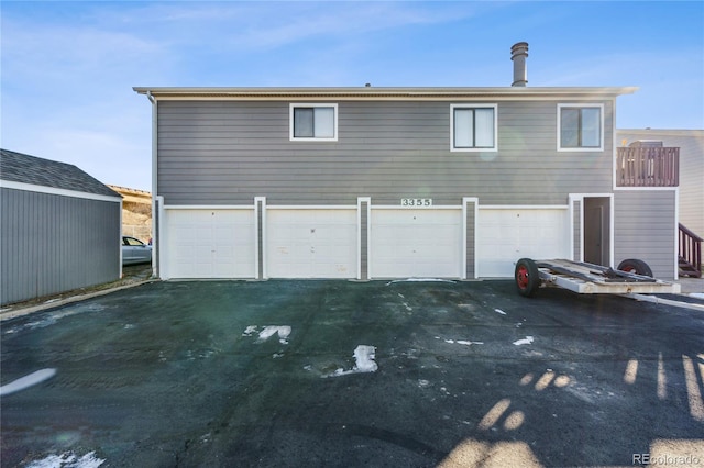 rear view of property featuring a garage