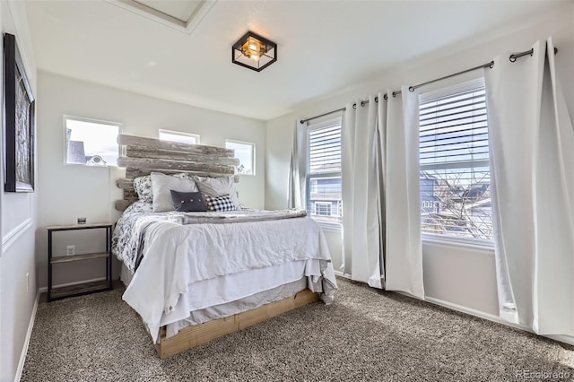 carpeted bedroom with multiple windows