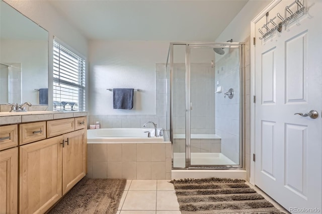 bathroom featuring plus walk in shower, vanity, and tile patterned floors