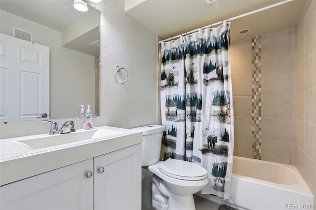 full bathroom featuring shower / bath combo, vanity, and toilet