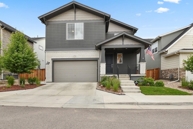 11151 W 53rd Dr, Wheat Ridge, CO 80033 - craftsman-style house featuring brick siding, a garage, concrete driveway, and a porch