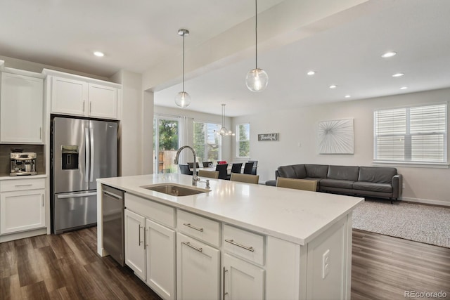 11151 W 53rd Dr, Wheat Ridge, CO 80033 - kitchen featuring stainless steel appliances, dark wood finished floors, white cabinets, recessed lighting, and open floor plan