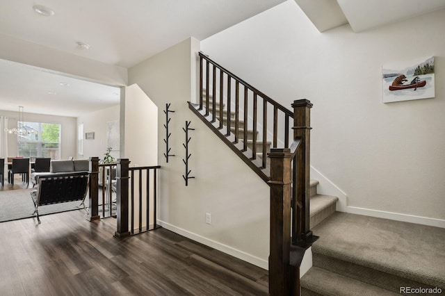 11151 W 53rd Dr, Wheat Ridge, CO 80033 - stairs featuring wood finished floors and a chandelier