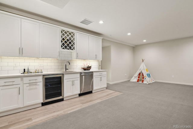11151 W 53rd Dr, Wheat Ridge, CO 80033 - indoor wet bar with stainless steel dishwasher, wine cooler, recessed lighting, decorative backsplash, and light colored carpet