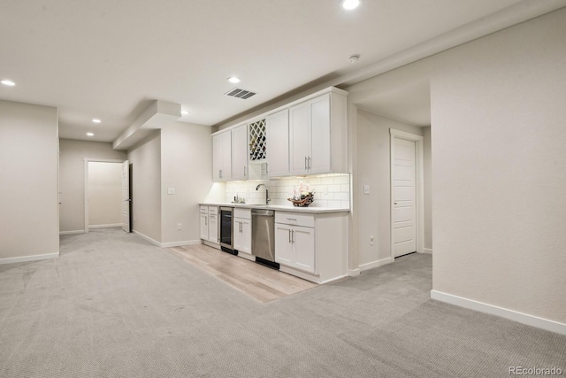 11151 W 53rd Dr, Wheat Ridge, CO 80033 - indoor wet bar featuring stainless steel dishwasher, light colored carpet, recessed lighting, tasteful backsplash, and wine cooler