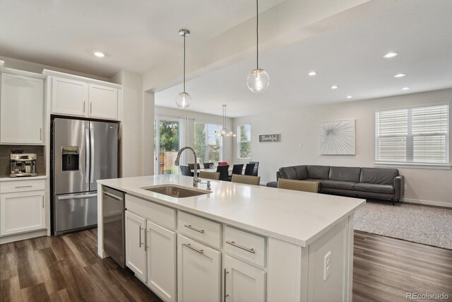 11151 W 53rd Dr, Wheat Ridge, CO 80033 - kitchen featuring stainless steel appliances, dark wood-type flooring, white cabinetry, recessed lighting, and open floor plan