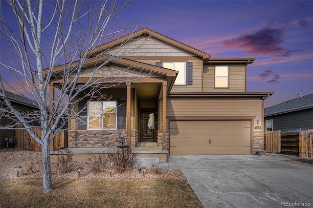 view of front of house with a porch, an attached garage, fence, stone siding, and concrete driveway