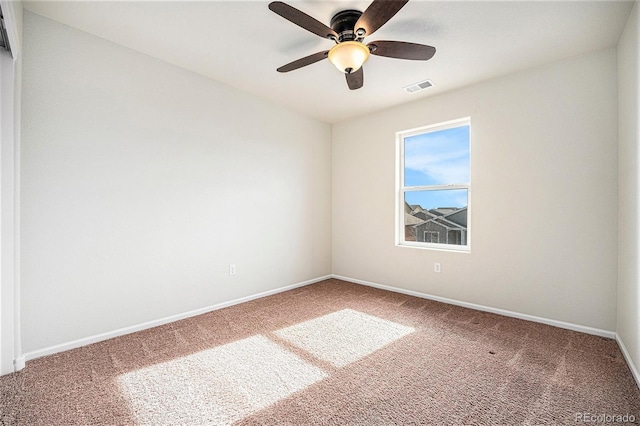 unfurnished room featuring a ceiling fan, carpet, visible vents, and baseboards