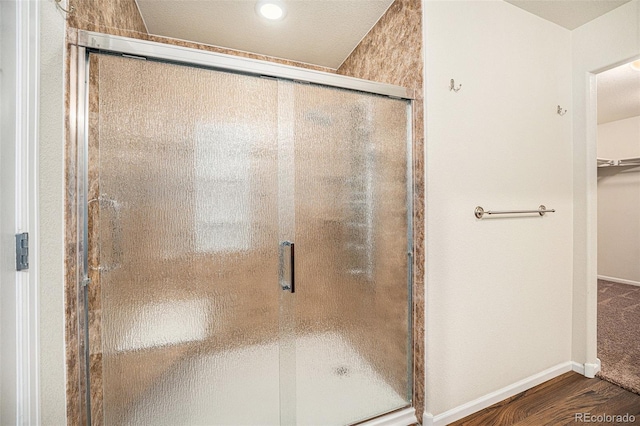 1788 Taos St, Brighton, CO 80603 - bathroom featuring wood finished floors, a stall shower, and baseboards