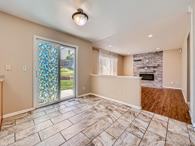 3708 S Lisbon Way, Aurora, CO 80013 - unfurnished living room featuring baseboards and a large fireplace