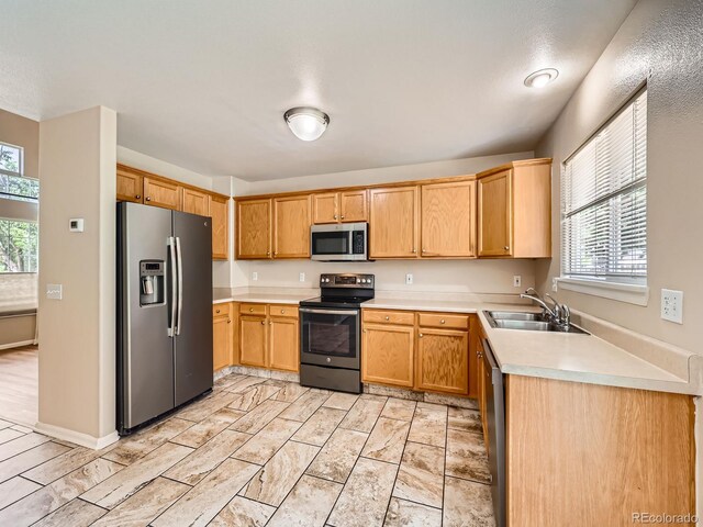 3708 S Lisbon Way, Aurora, CO 80013 - kitchen with stainless steel appliances, healthy amount of natural light, and light countertops