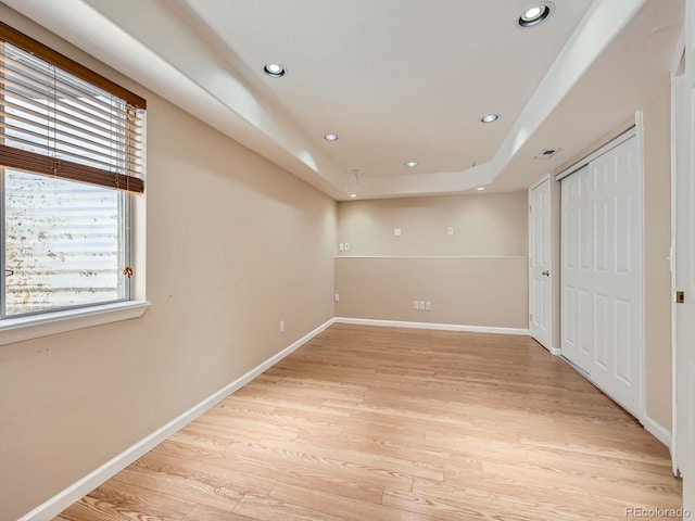 3708 S Lisbon Way, Aurora, CO 80013 - unfurnished bedroom with light wood-type flooring, recessed lighting, a tray ceiling, and a closet