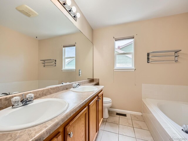 3708 S Lisbon Way, Aurora, CO 80013 - bathroom with plenty of natural light, a garden tub, double vanity, and tile patterned floors