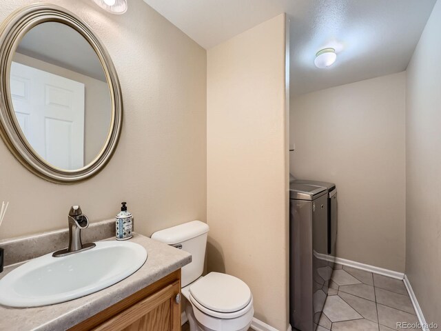 3708 S Lisbon Way, Aurora, CO 80013 - bathroom featuring washer and dryer, tile patterned flooring, and vanity