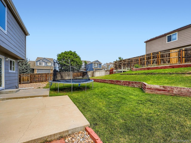 3708 S Lisbon Way, Aurora, CO 80013 - fenced backyard featuring a trampoline, a patio area, and a residential view