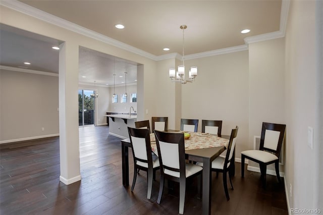 dining room featuring ornamental molding, dark hardwood / wood-style floors, and a chandelier