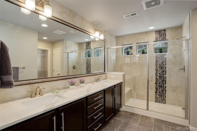 bathroom featuring a shower with door, vanity, and tile patterned flooring