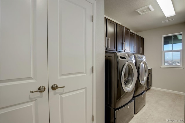 laundry room with cabinets and washing machine and clothes dryer