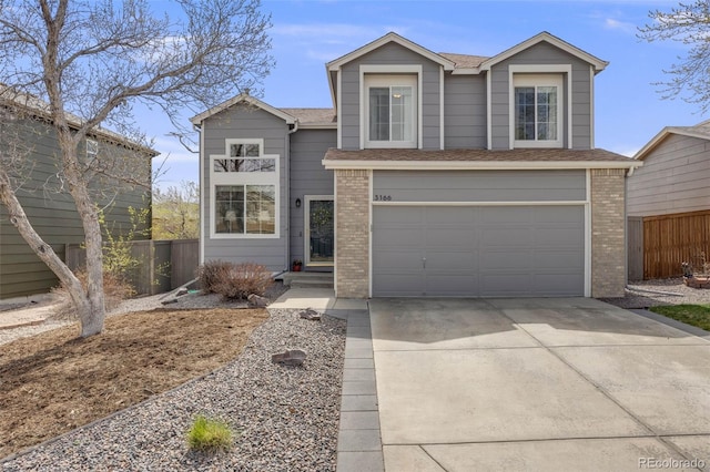 traditional-style home featuring concrete driveway, a shingled roof, fence, a garage, and brick siding