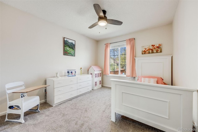 bedroom with ceiling fan, baseboards, carpet flooring, and a textured ceiling