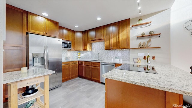 kitchen featuring tasteful backsplash, brown cabinets, appliances with stainless steel finishes, a peninsula, and open shelves