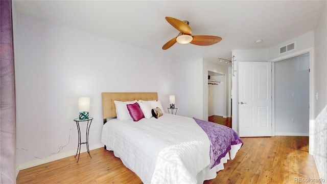 bedroom featuring visible vents, baseboards, light wood-type flooring, a closet, and a ceiling fan